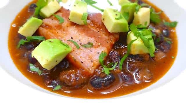 A thick and rich Mexican black bean soup recipe: a bowl of silky smooth smothered beans with pancetta and fresh cilantro!