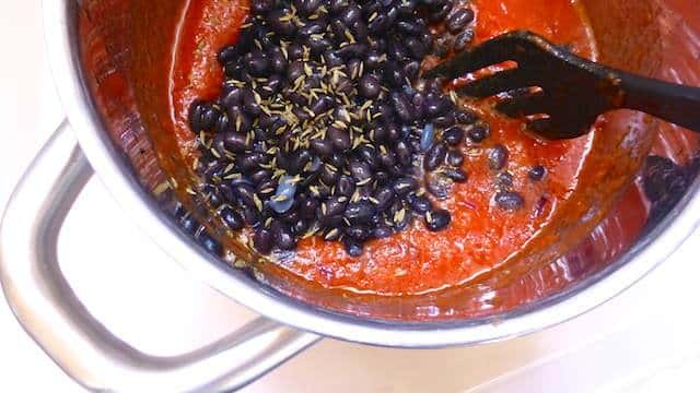 A thick and rich Mexican black bean soup recipe: a bowl of silky smooth smothered beans with pancetta and fresh cilantro!