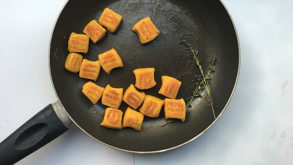 Crunchy pan seared pumpkin gnocchi with ricotta and parmesan cheese... This homemade gnocchi recipe is a great autumn side dish!