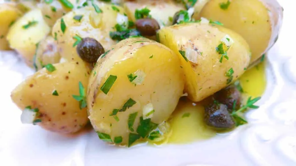 My drop dead simple classic potato salad recipe with olive oil and lots of fresh herbs and capers: a light potato side dish!