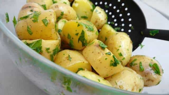 My drop dead simple classic potato salad recipe with olive oil and lots of fresh herbs and capers: a light potato side dish!