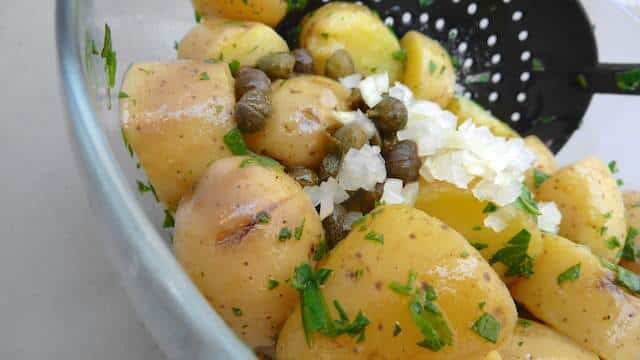 My drop dead simple classic potato salad recipe with olive oil and lots of fresh herbs and capers: a light potato side dish!