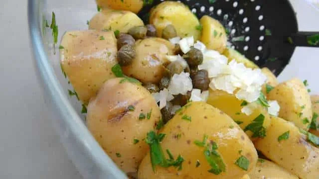 My drop dead simple classic potato salad recipe with olive oil and lots of fresh herbs and capers: a light potato side dish!