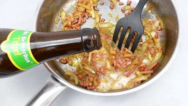 Succulent baked pork chops in beer sauce with crunchy bacon bits and soft onion... No need to say how fantastic this recipe tastes!