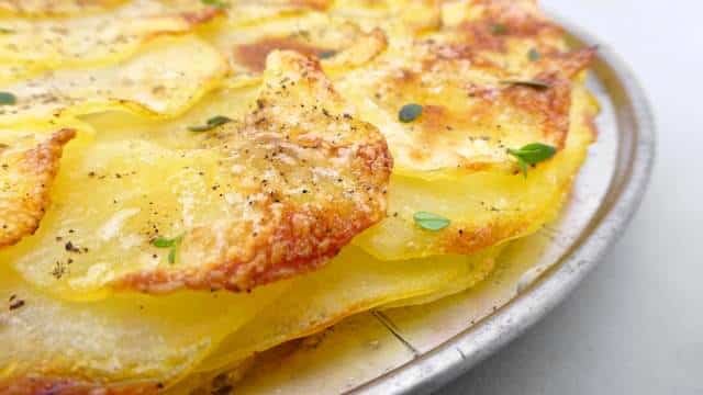 A classic French potato galette recipe: crunchy scalloped potatoes on top, buttery soft and smooth potatoes underneath...
