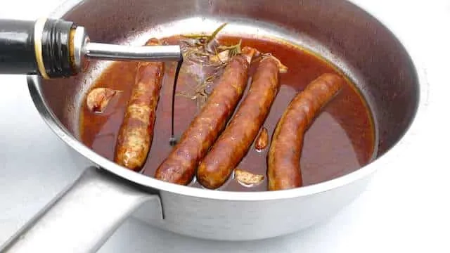 Delicious roasted sausage with soft garlic cloves and red wine... Served over buttery mashed potatoes or creamy polenta: flavor bomb!