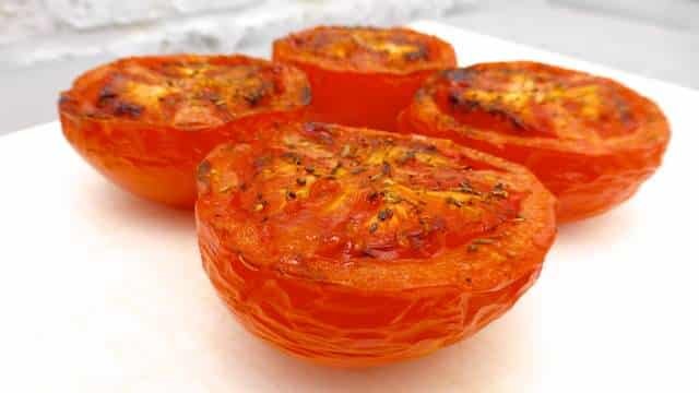 Baked tomatoes recipe: tomatoes wrapped in bacon and grilled to perfection! Great vegetable side dish for turkey, chicken or pork!