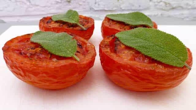 Baked tomatoes recipe: tomatoes wrapped in bacon and grilled to perfection! Great vegetable side dish for turkey, chicken or pork!
