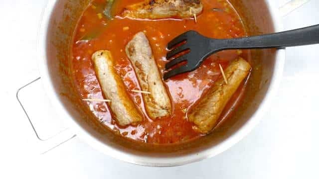 Braciole di manzo, juicy Italian stuffed beef rolls with olives, eggs, ham and basil! Braised in a chunky tomato sauce...