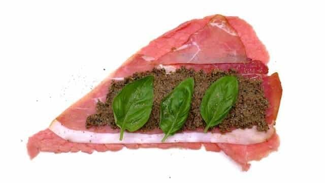 Braciole di manzo, juicy Italian stuffed beef rolls with olives, eggs, ham and basil! Braised in a chunky tomato sauce...