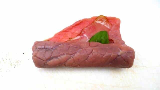 Braciole di manzo, juicy Italian stuffed beef rolls with olives, eggs, ham and basil! Braised in a chunky tomato sauce...