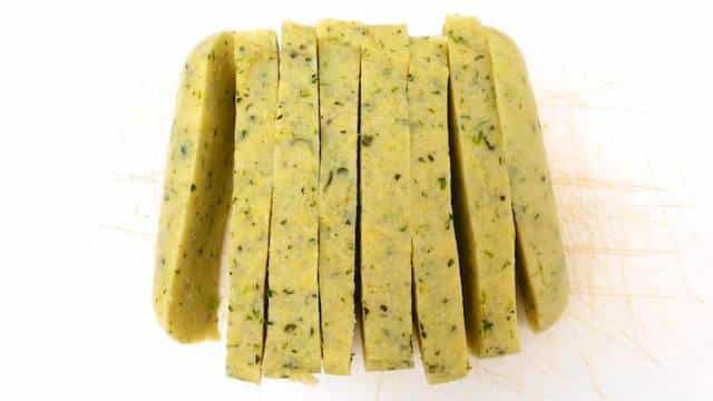 Try this very easy grilled polenta: with pine nuts, black olives and grated parmesan cheese... Serve it as a light lunch or a veggie side dish!