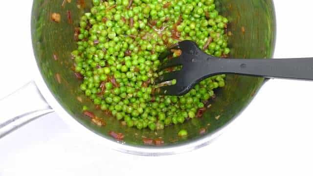 Pea stir fry with explosive Asian flavors: oyster sauce, freshly grated ginger, soy sauce, sriracha chili sauce, tomato paste and lemon juice!