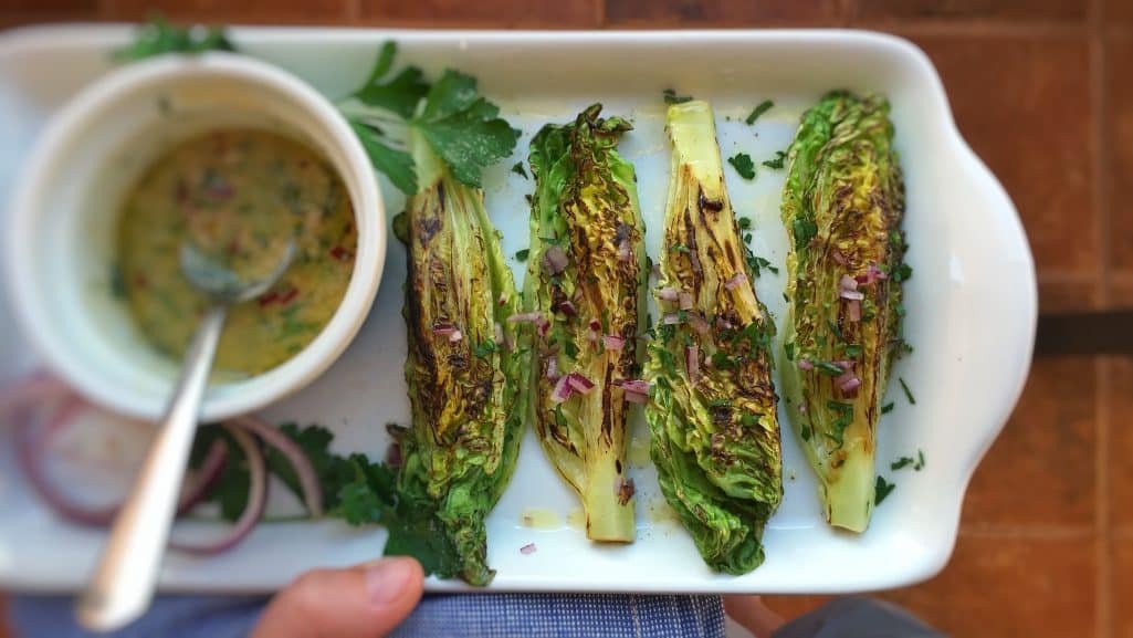 Delicious grilled romaine lettuce with grated parmesan cheese and olive oil, a surprising vegetable side dish for chicken or pork!