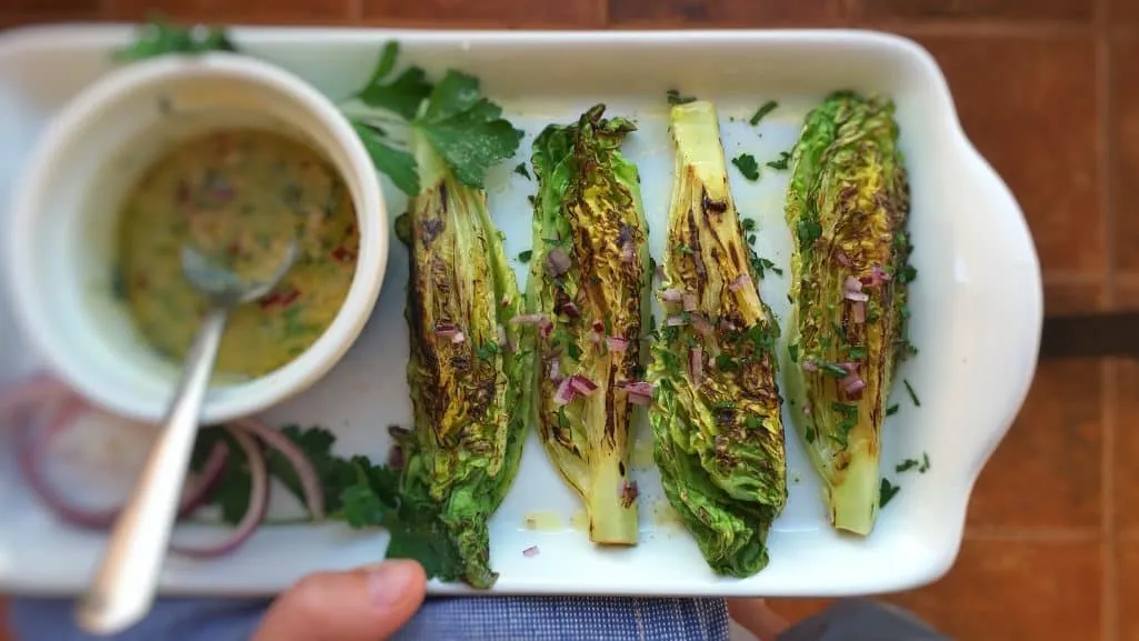 Delicious grilled romaine lettuce with grated parmesan cheese and olive oil, a surprising vegetable side dish for chicken or pork!