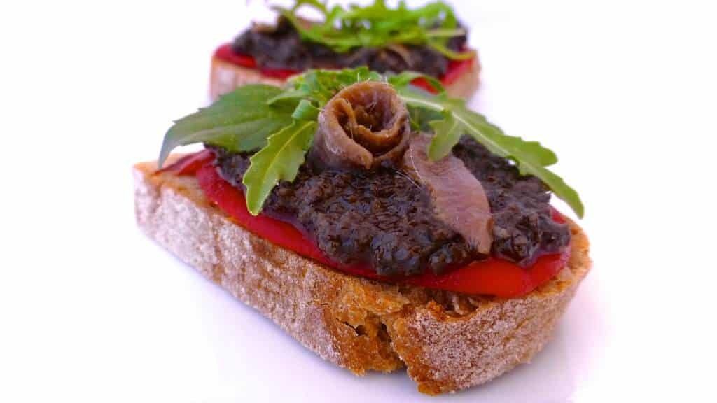 This mediterranean black olive tapenade is a delicious sandwich spread or healthy dipping sauce! It's a very popular dip in France as well!