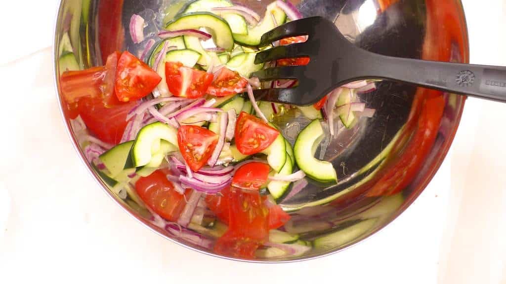 An easy Thai recipe: chilled Thai beef salad with cucumber, tomatoes, mint, cilantro and red onion in a spicy fish sauce and lemon marinade!
