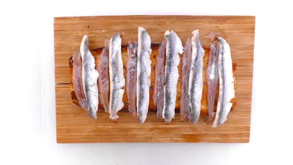 Crunchy Spanish tosta matrimonio or pickled anchovies and salted anchovies on a slice of pan con tomate, the perfect wedding!