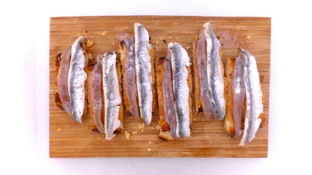 Crunchy Spanish tosta matrimonio or pickled anchovies and salted anchovies on a slice of pan con tomate, the perfect wedding!