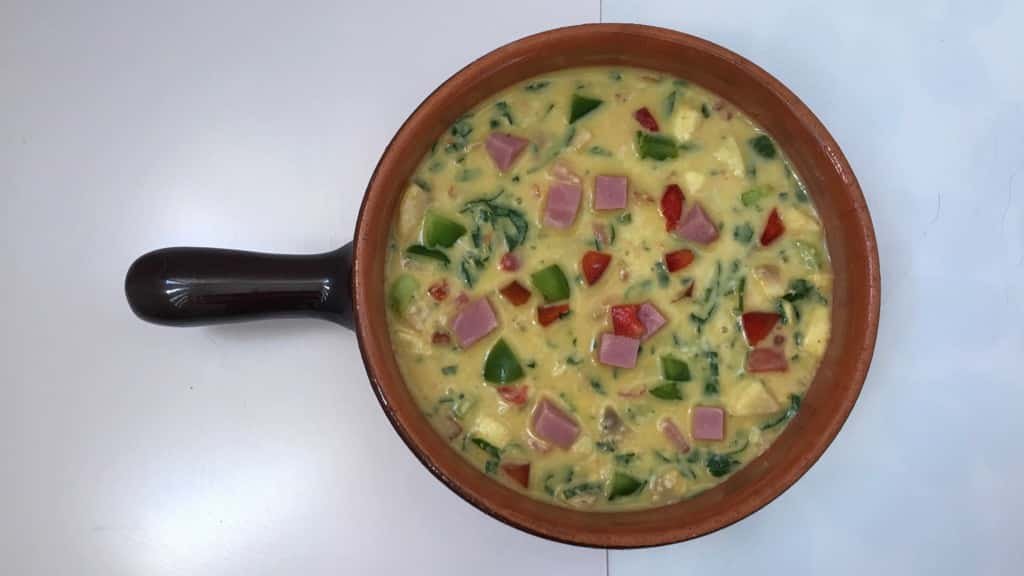 A thick oven baked omelet with bacon, grated cheese and colorful vegetables: this breakfast casserole is a great way to use leftovers!