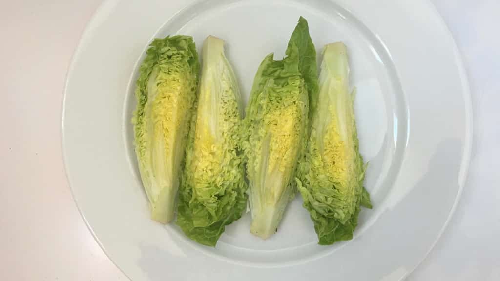 Delicious grilled romaine lettuce with grated parmesan cheese and olive oil, a surprising vegetable side dish for chicken or pork!
