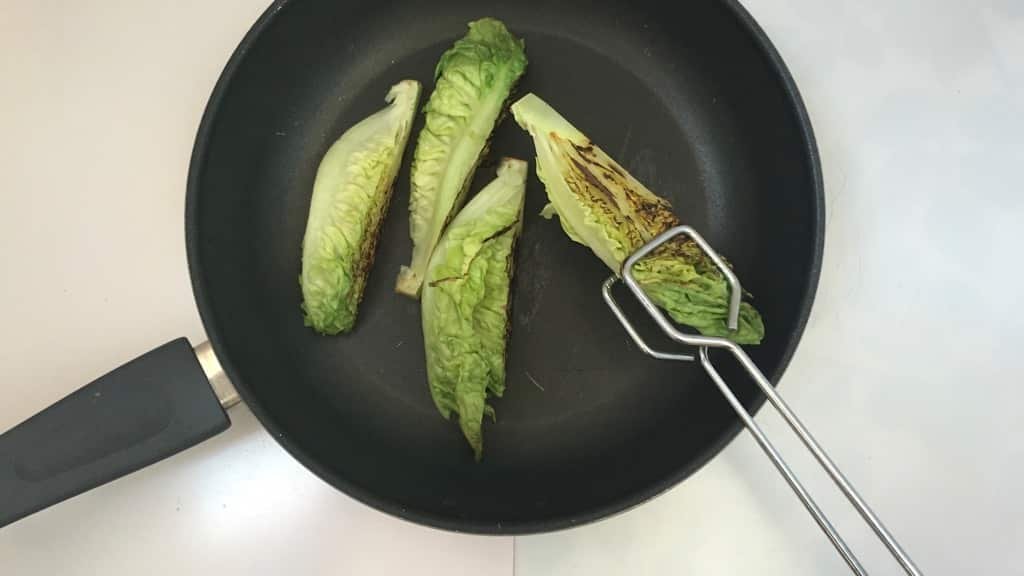 Delicious grilled romaine lettuce with grated parmesan cheese and olive oil, a surprising vegetable side dish for chicken or pork!