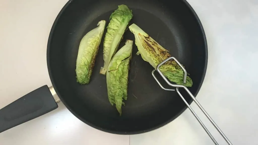 Delicious grilled romaine lettuce with grated parmesan cheese and olive oil, a surprising vegetable side dish for chicken or pork!