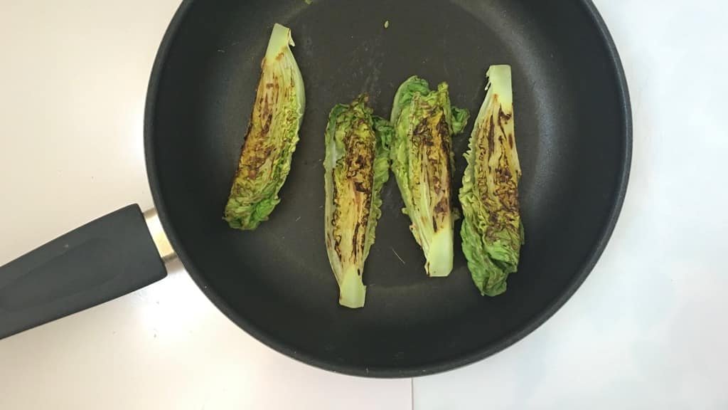 Delicious grilled romaine lettuce with grated parmesan cheese and olive oil, a surprising vegetable side dish for chicken or pork!