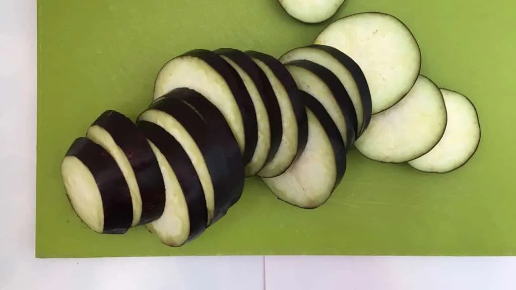 This refreshing and soothing eggplant in yogurt sauce is a great side dish to serve with your next spicy Indian curry dinner!