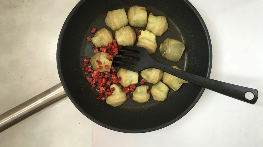 Pan fried artichokes in white wine sauce with dried chorizo sausage and fresh parsley! This is a great side dish for grilled steaks...