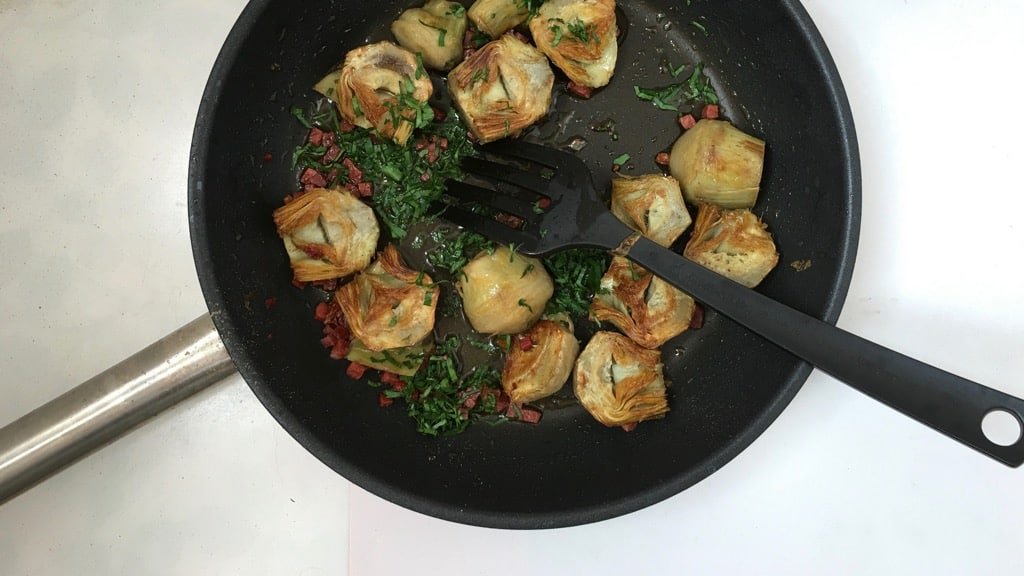 Pan fried artichokes in white wine sauce with dried chorizo sausage and fresh parsley! This is a great side dish for grilled steaks...