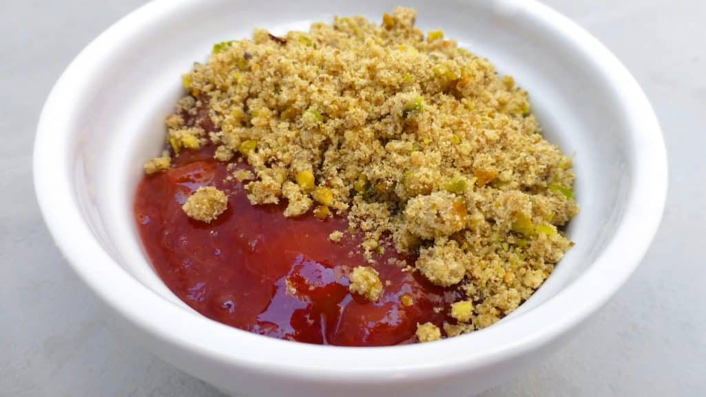 Rhubarb crumble recipe: sugary smooth rhubarb and strawberry tomato jam topped with a crunchy salted pistachio crumble!