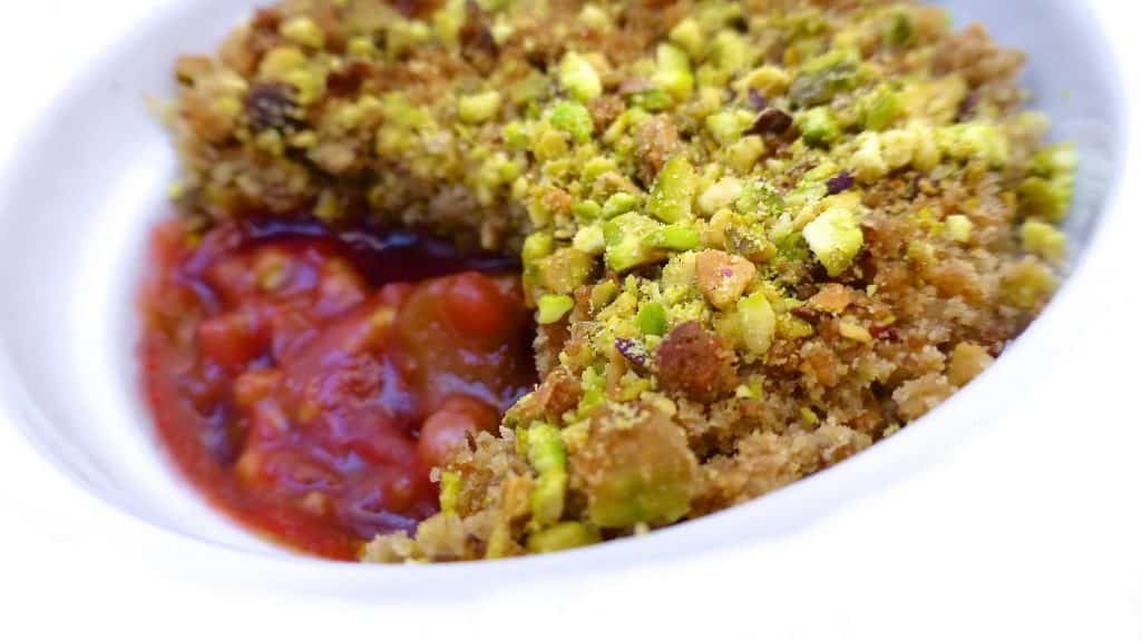 Easy Vanilla & Strawberry Tomato Jam Rhubarb crumble recipe: sugary smooth rhubarb and strawberry tomato jam topped with a crunchy salted pistachio crumble!