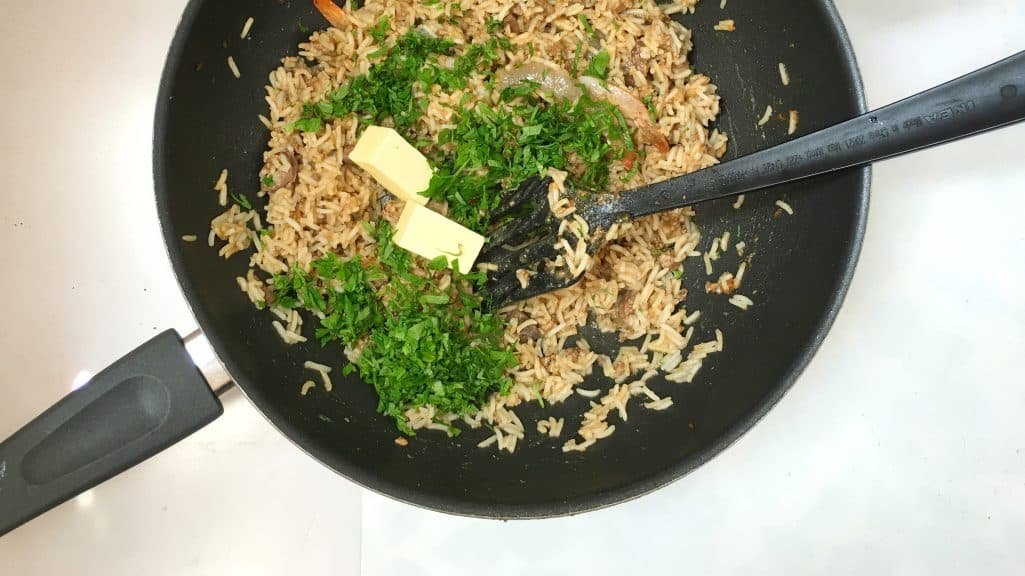 Dirty rice with shrimp? You will love this bowl of stir fried buttery rice, chopped liver bits, shrimp and hints of cumin and paprika!