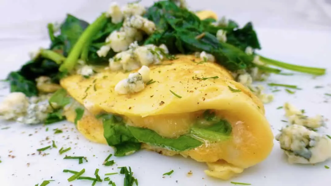 Here's a quick and easy spinach omelette with gooey stilton blue cheese and garlicky spinach... What a great breakfast or brunch recipe idea!