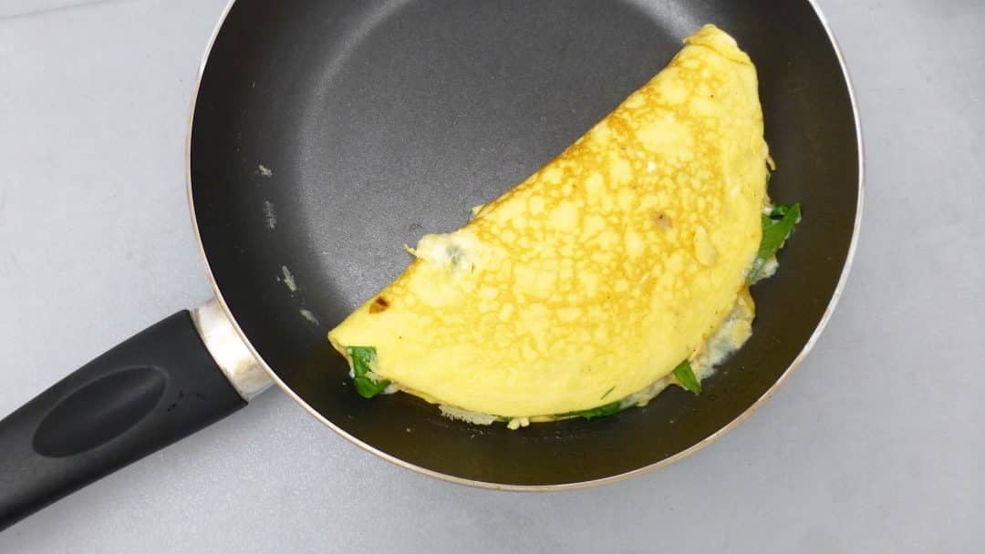Here's a quick and easy spinach omelette with gooey stilton blue cheese and garlicky spinach... What a great breakfast or brunch recipe idea!