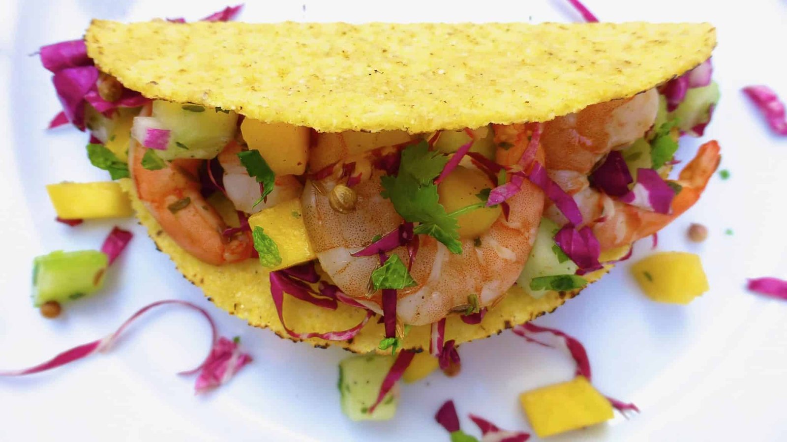 Here's my crunchy shrimp tacos recipe, just the way I like it. With juicy grilled shrimp and a fresh cucumber, chopped cilantro and a sweet mango salsa. Dig in!