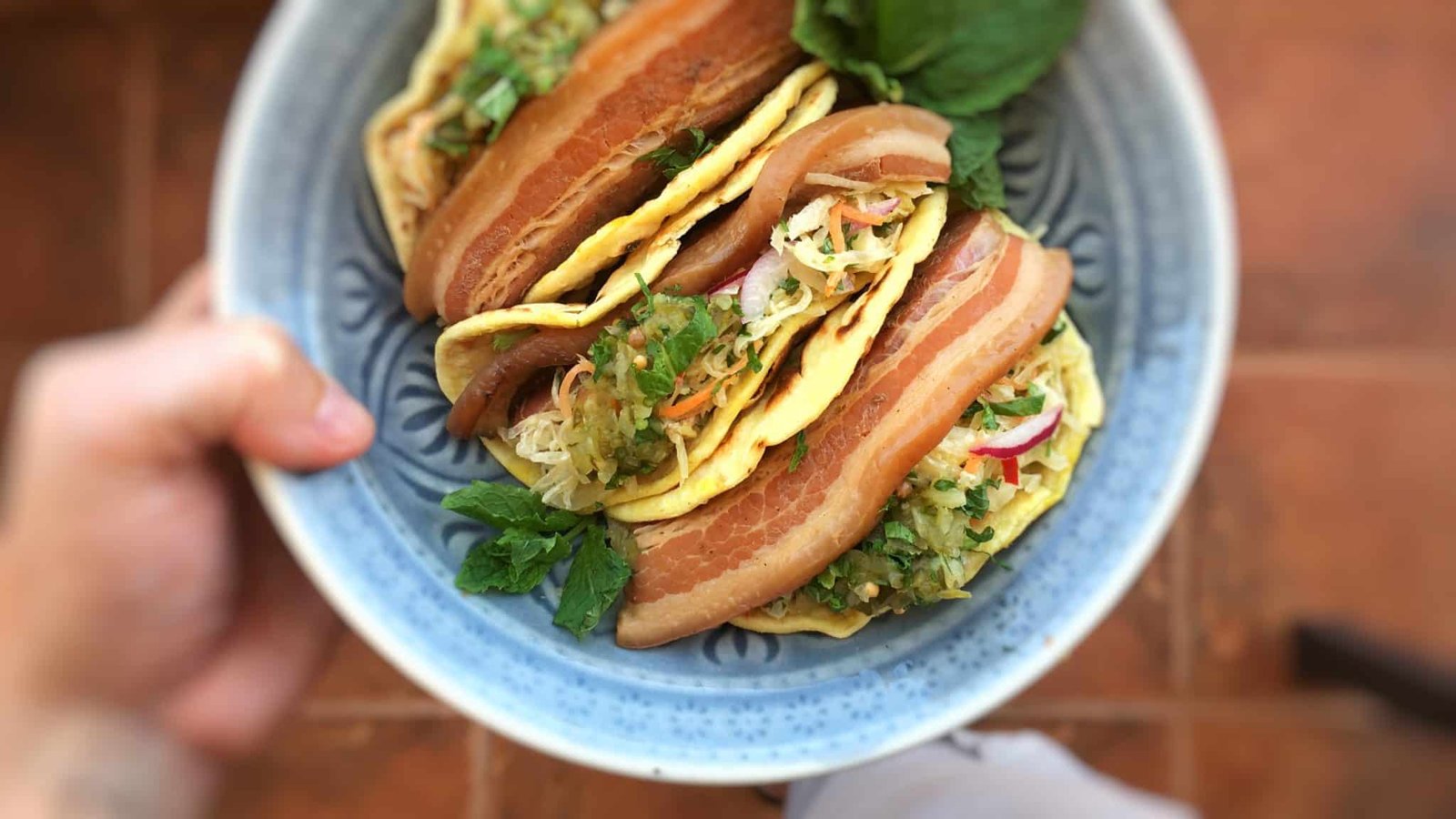 Beer and soy sauce braised pork belly tacos topped off with a refreshing sauerkraut salad and a dollop of homemade sweet relish... These tacos are to die for!
