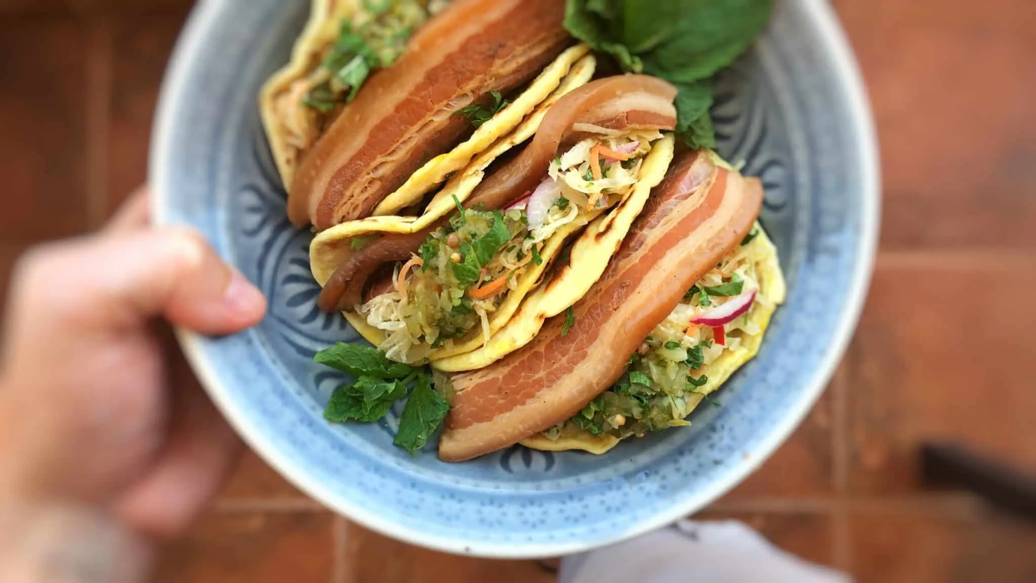 Beer and soy sauce braised pork belly tacos topped off with a refreshing sauerkraut salad and a dollop of homemade sweet relish... These tacos are to die for!