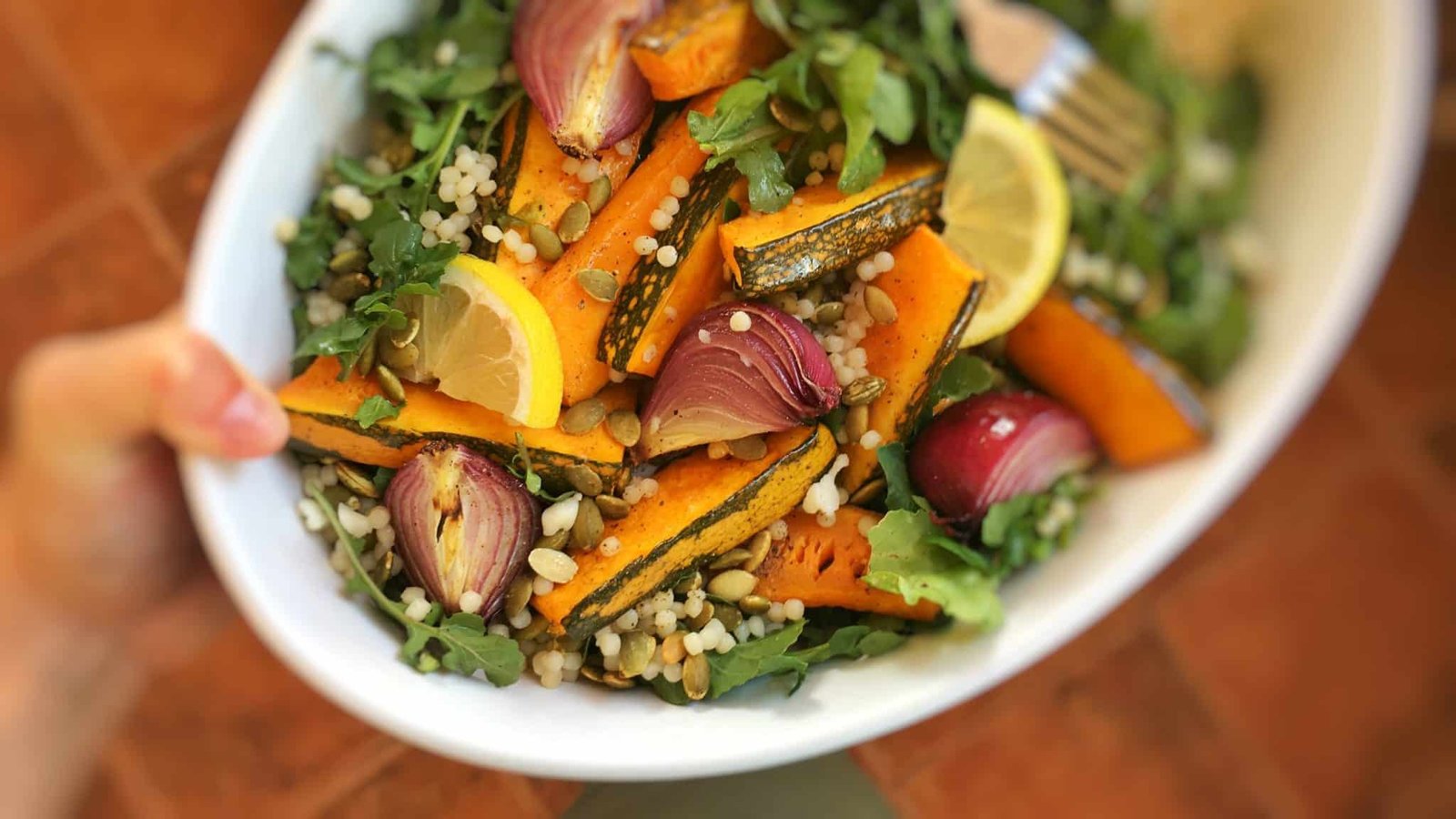 Here's a wholesome roasted pumpkin salad with roasted red onion, arugula, pearl couscous and pumpkin seeds. What a top notch vegetarian dinner this is as well