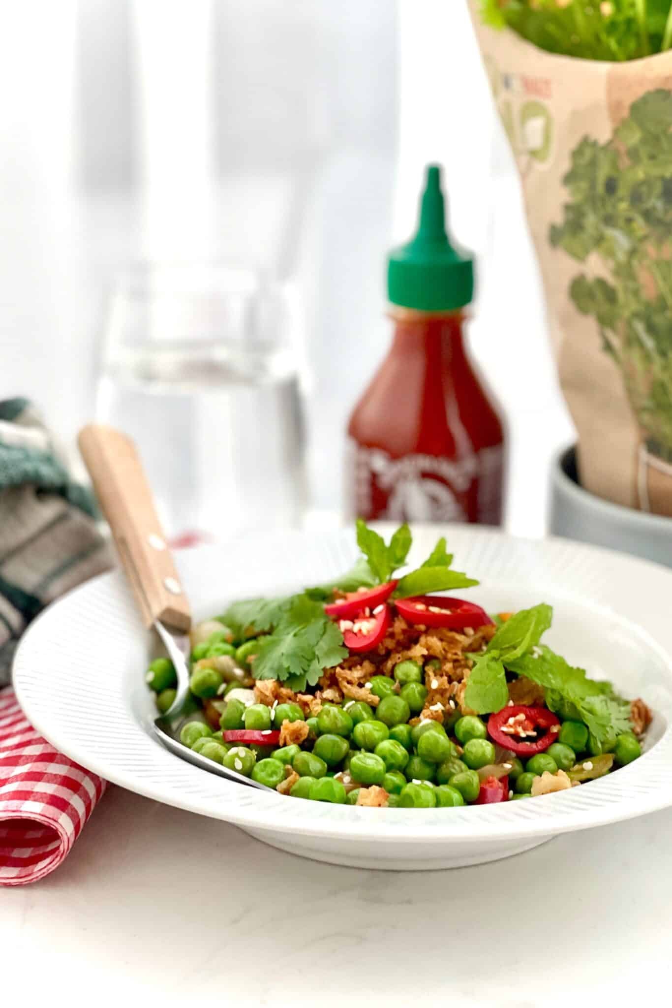 Pea stir fry with explosive Asian flavors: oyster sauce, freshly grated ginger, soy sauce, sriracha chili sauce, tomato paste and lemon juice!