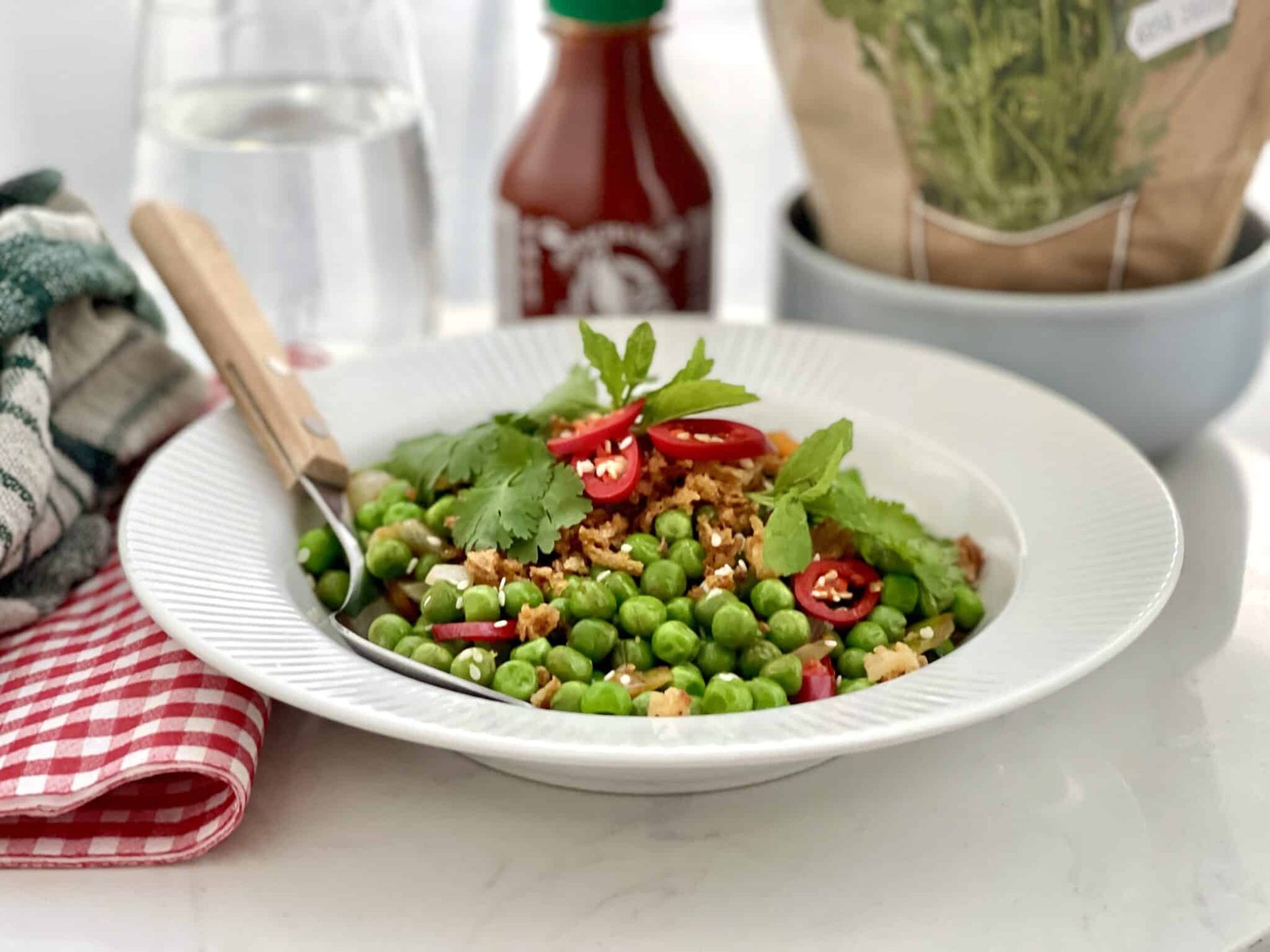 Pea stir fry with explosive Asian flavors: oyster sauce, freshly grated ginger, soy sauce, sriracha chili sauce, tomato paste and lemon juice!