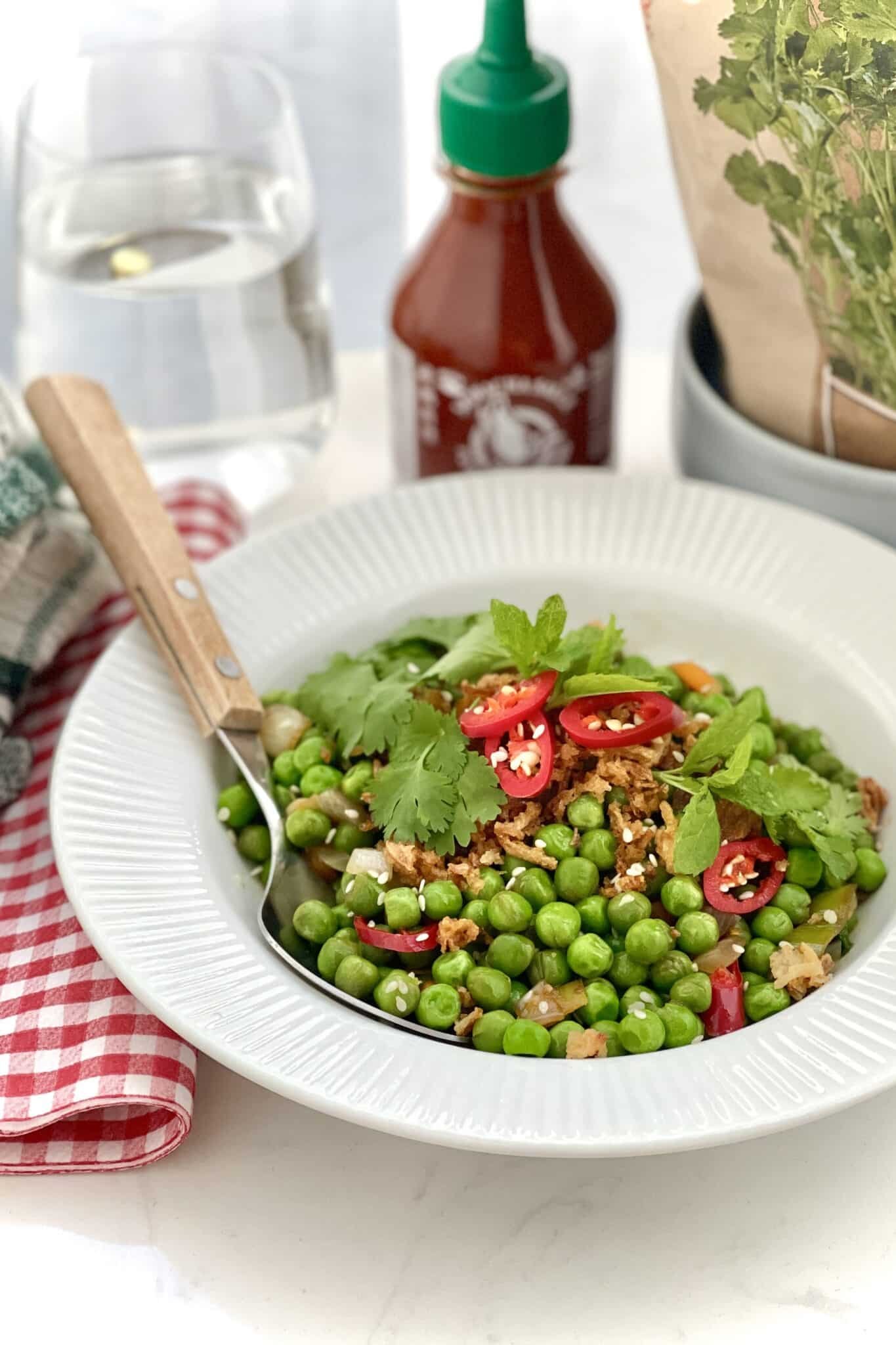 Pea stir fry with explosive Asian flavors: oyster sauce, freshly grated ginger, soy sauce, sriracha chili sauce, tomato paste and lemon juice!
