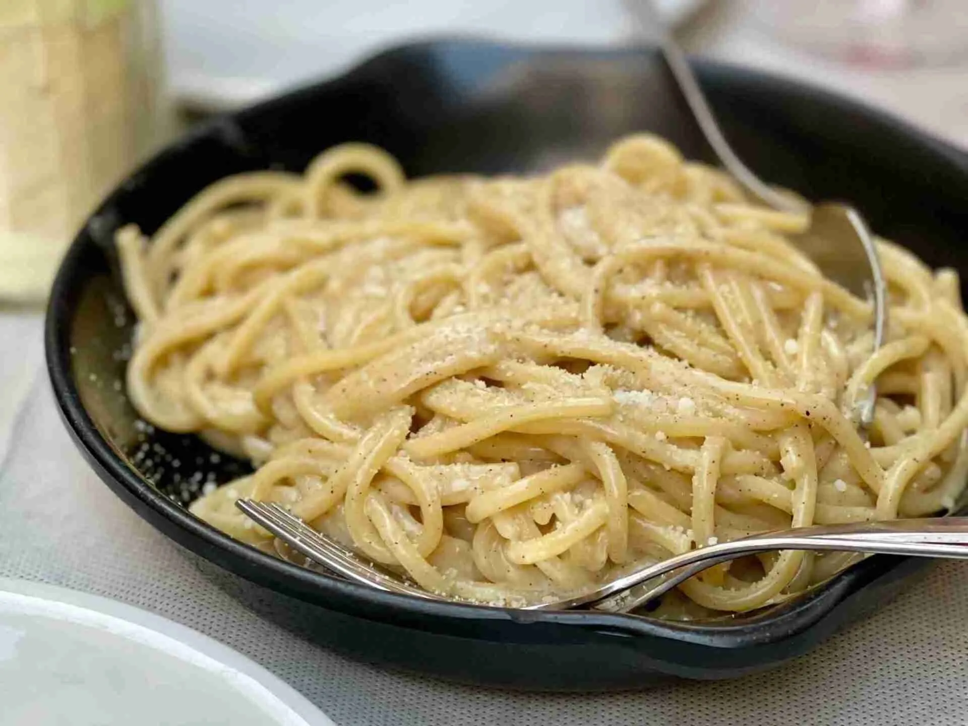 Classic cacio e pepe pasta: simple Italian spaghetti dish with grated pecorino cheese and freshly ground pepper... Yum!