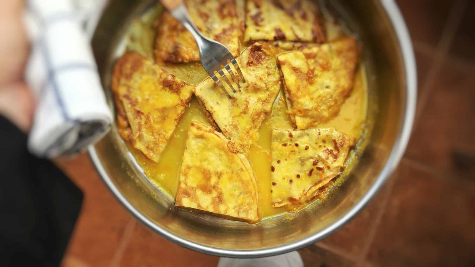 Homemade thin crepes in a sugary orange and Grand Marnier sauce... this crepes suzette recipe is a must try! You will love it...