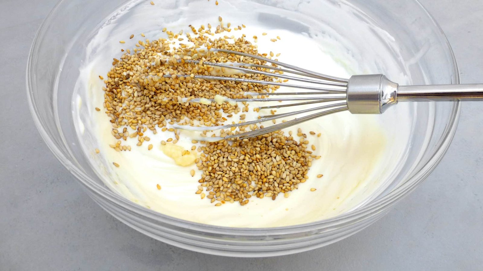 Looking for a homemade falafel sauce? Try out my simple yogurt falafel sauce with sesame oil: the best falafel diping sauce ever!