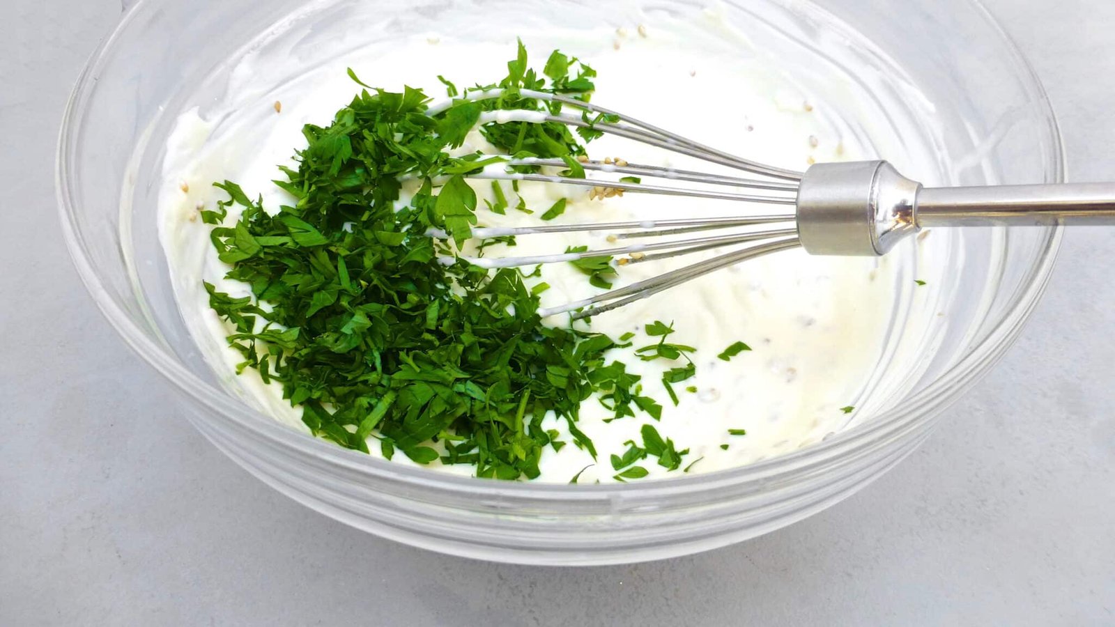 Looking for a homemade falafel sauce? Try out my simple yogurt falafel sauce with sesame oil: the best falafel diping sauce ever!