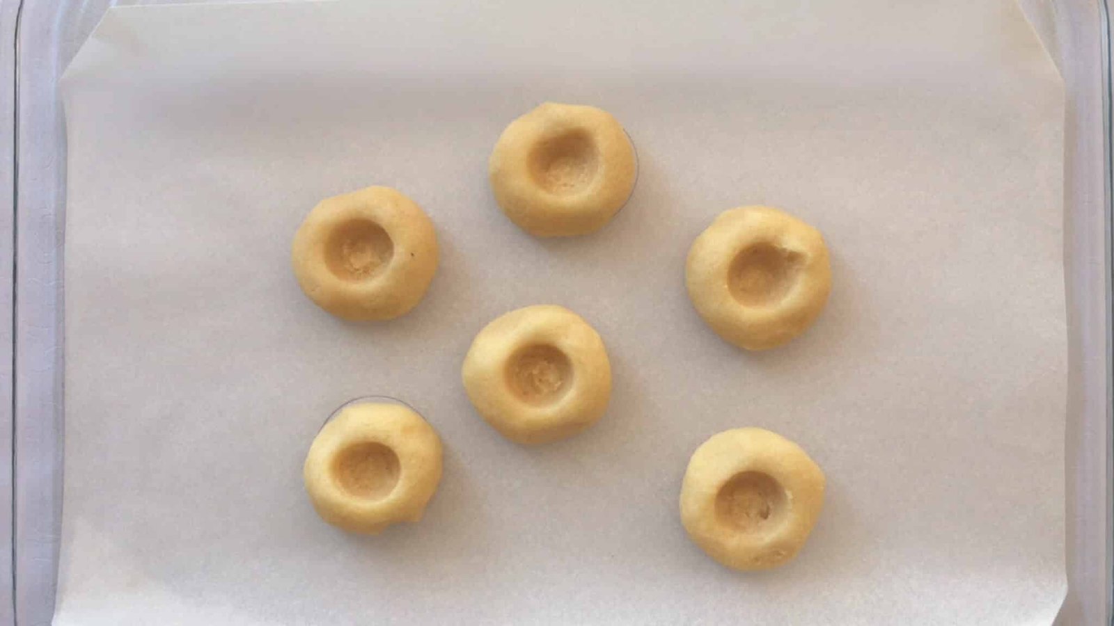 Sugary soft cookies filled with pumpkin jam filling and drizzled with homemade white glaze... You will love this thumbprint cookies recipe!
