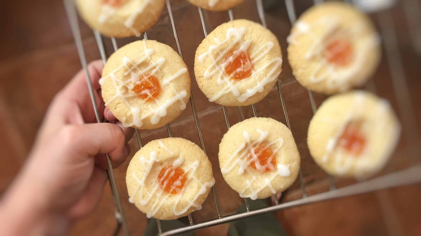 Sugary soft cookies filled with pumpkin jam filling and drizzled with homemade white glaze... You will love this thumbprint cookies recipe!