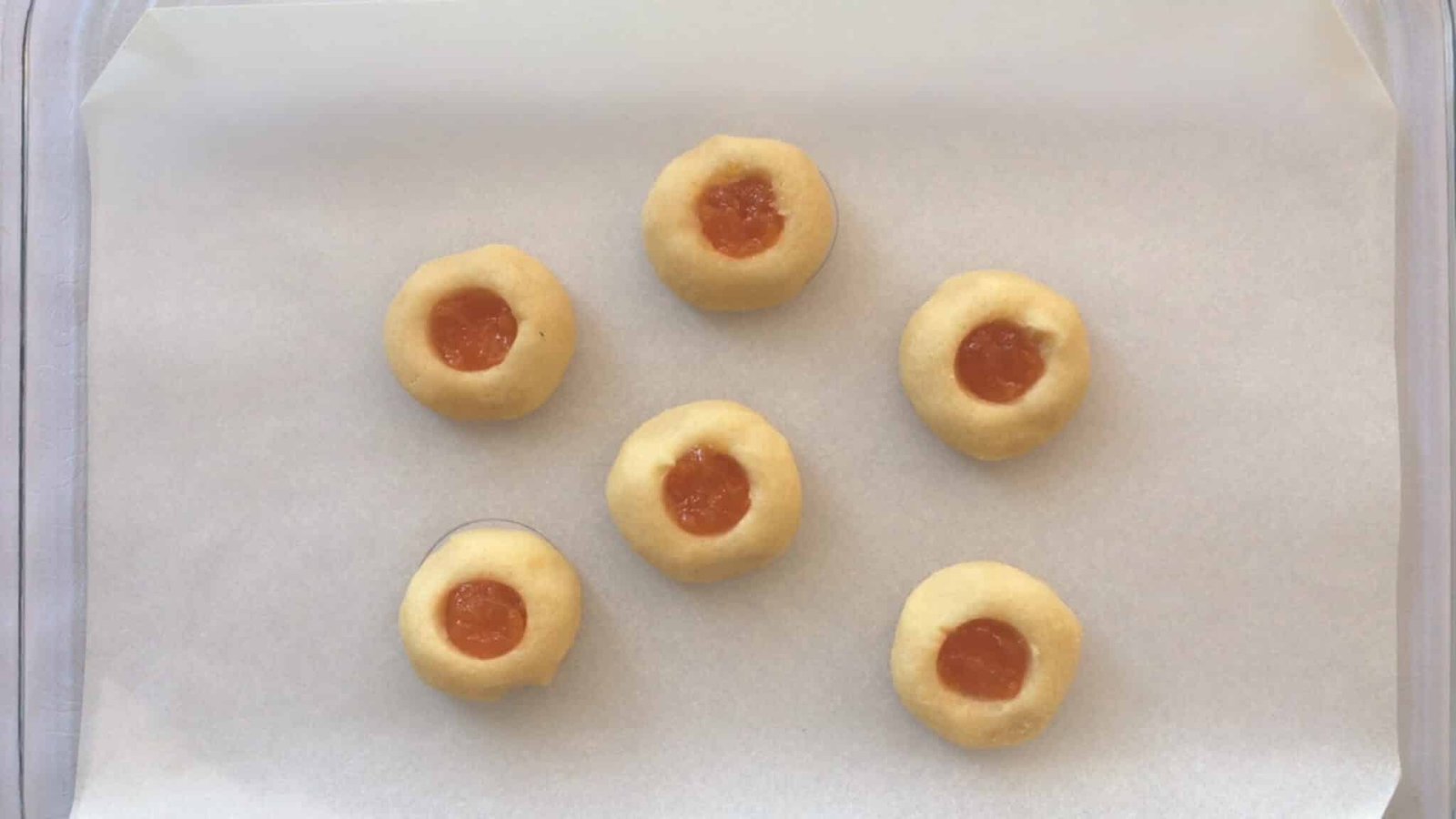 Sugary soft cookies filled with pumpkin jam filling and drizzled with homemade white glaze... You will love this thumbprint cookies recipe!
